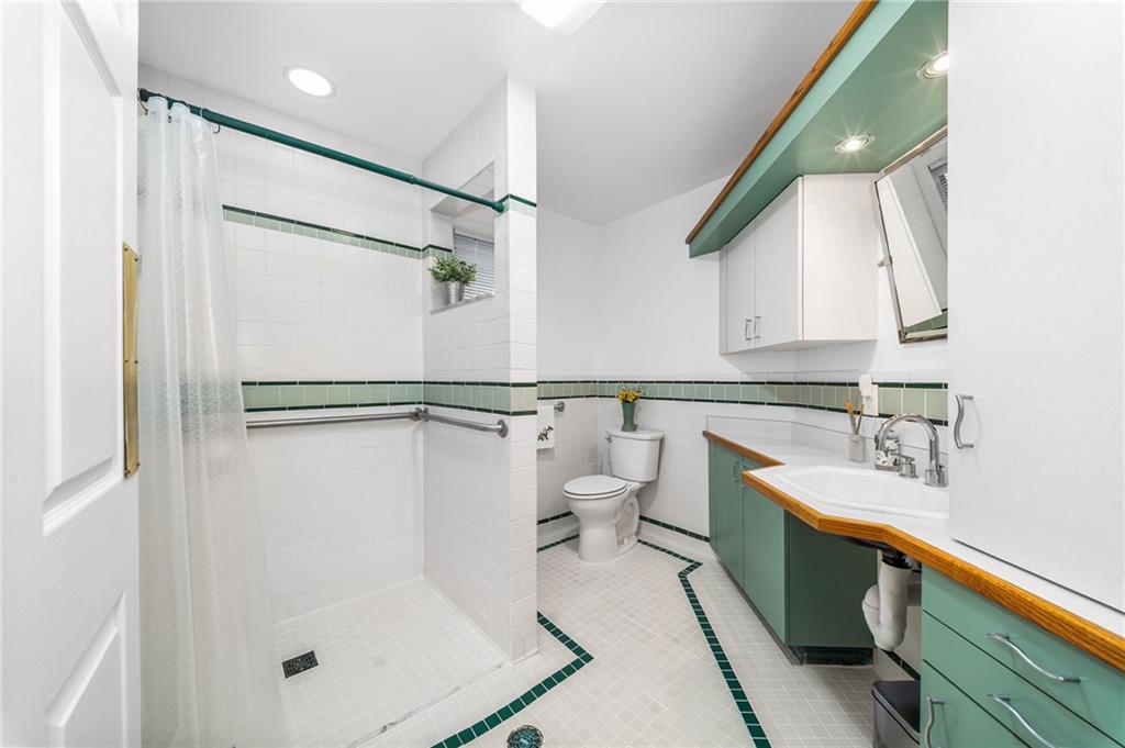 101 Buckingham Road Pittsburgh, PA 15215 - Photo 16 of 44 a bathroom with a sink a toilet and a mirror