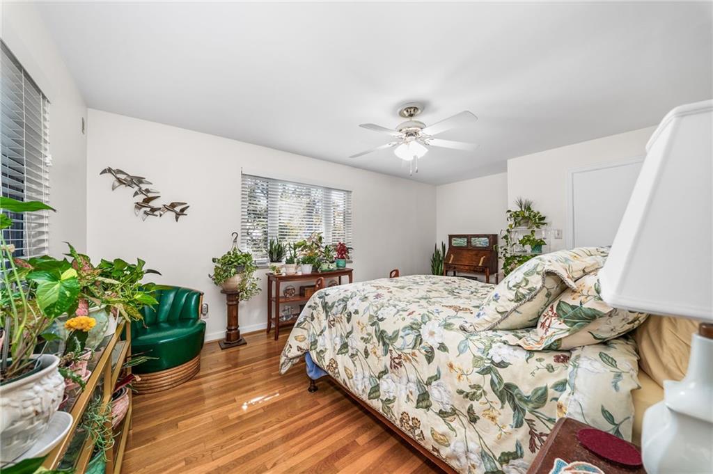101 Buckingham Road Pittsburgh, PA 15215 - Photo 18 of 44 a bed sitting in a bedroom next to a potted plant