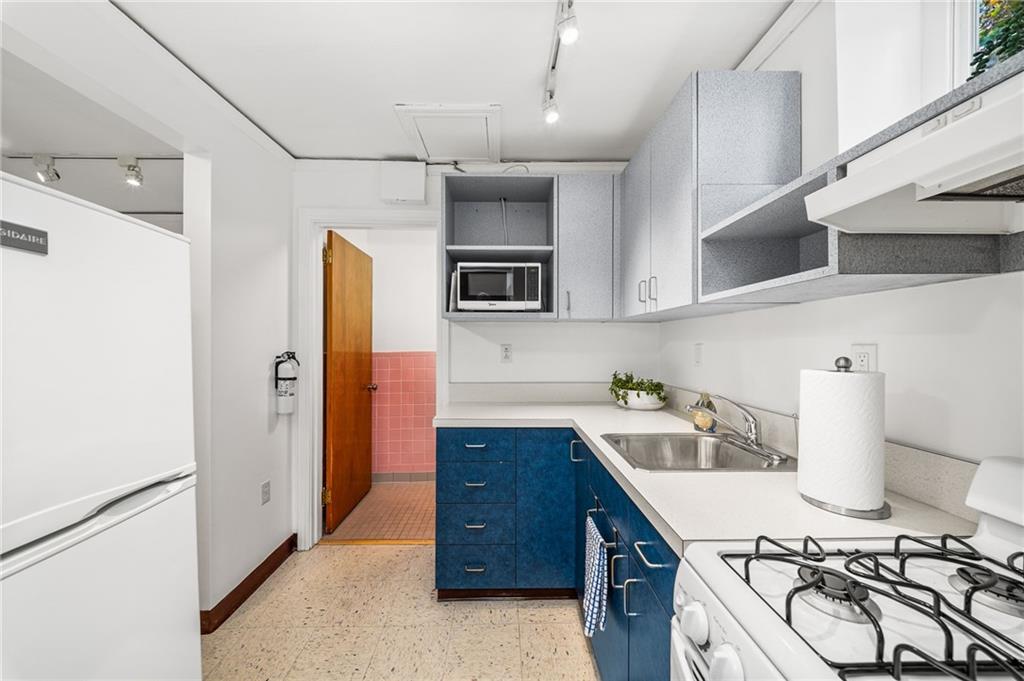 101 Buckingham Road Pittsburgh, PA 15215 - Photo 25 of 44 a kitchen with a refrigerator and a stove top oven