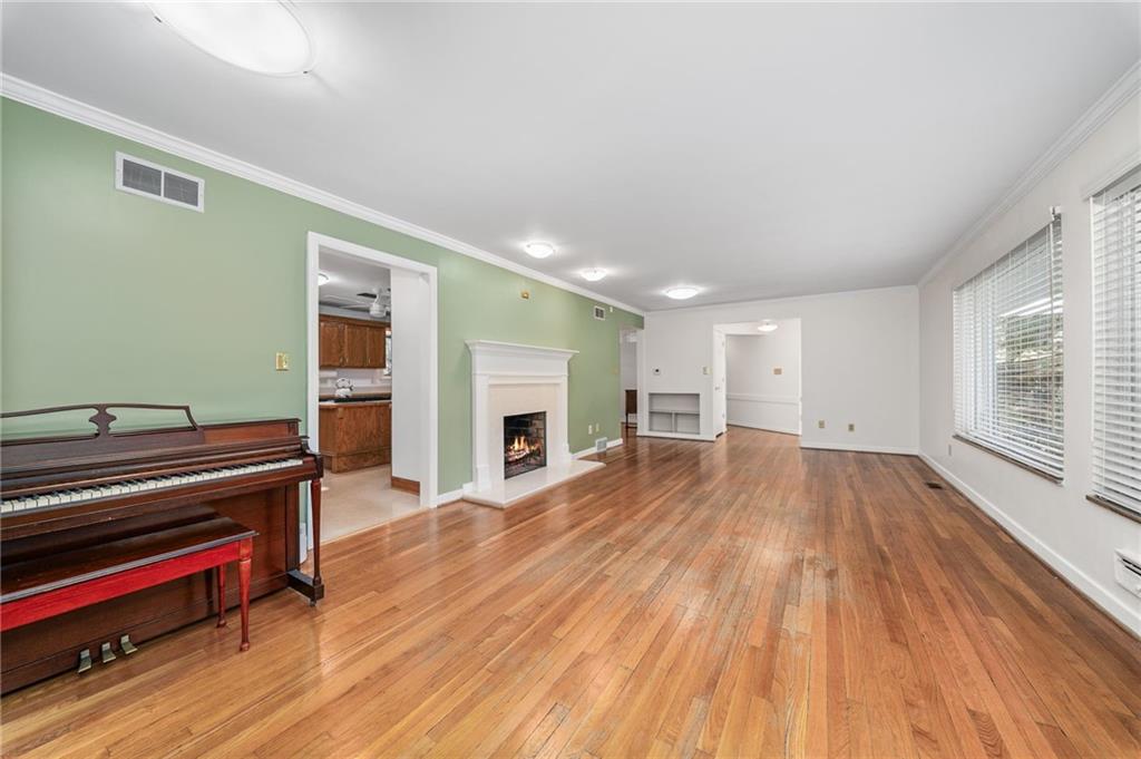 101 Buckingham Road Pittsburgh, PA 15215 - Photo 4 of 44 a view of empty room with wooden floor and fireplace