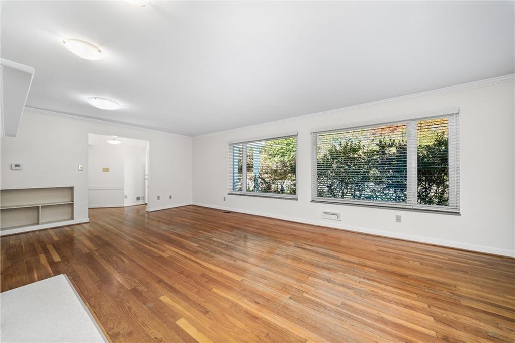 101 Buckingham Road Pittsburgh, PA 15215 - Photo 5 of 44 a view of an empty room with a window and wooden floor