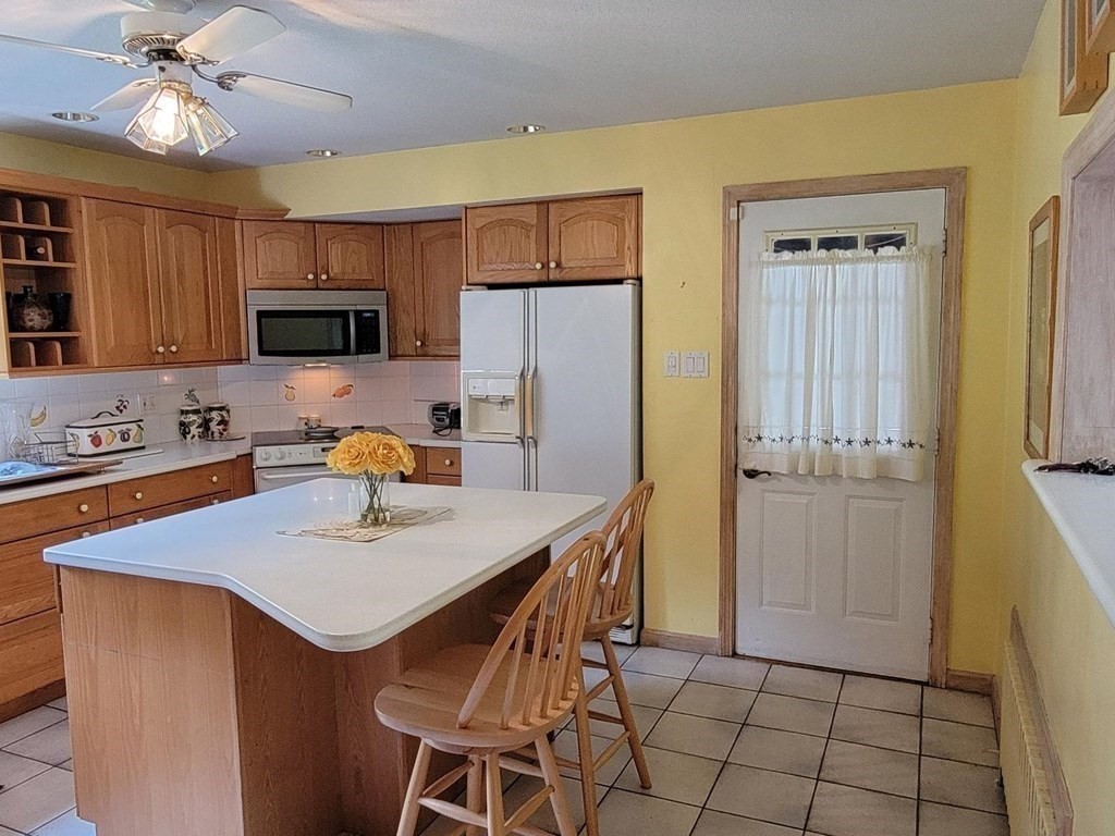 235 Belchertown Road Ware, MA 01082 - Photo 15 of 27 a kitchen with stainless steel appliances a sink a microwave a refrigerator and cabinets
