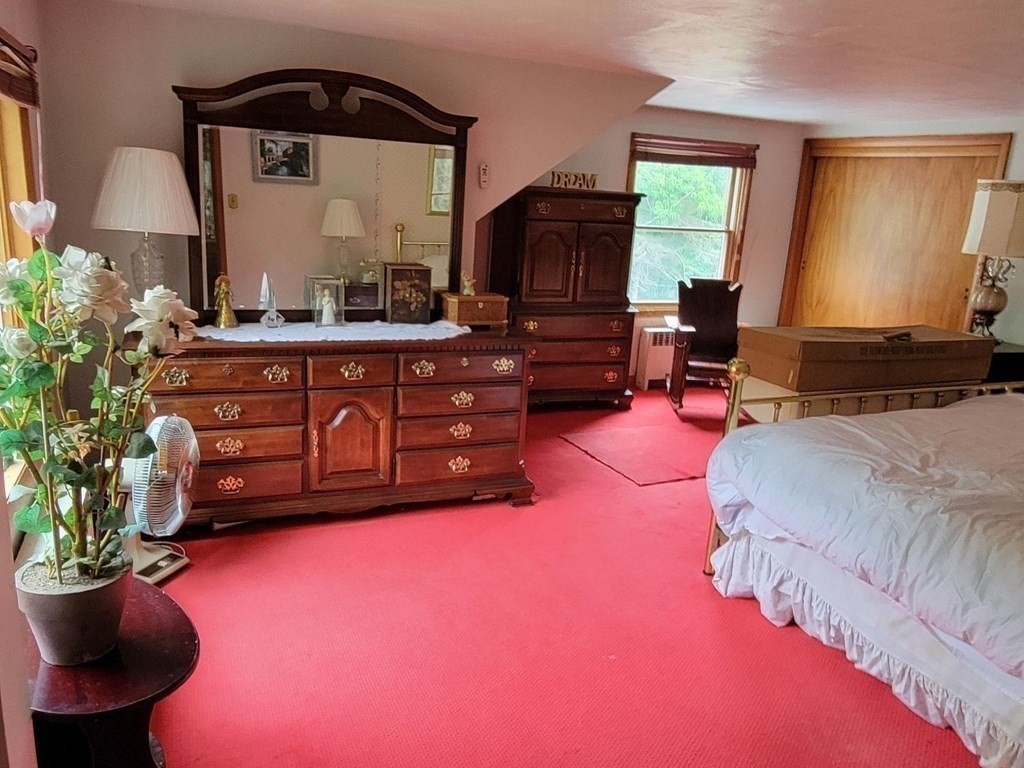 235 Belchertown Road Ware, MA 01082 - Photo 24 of 27 a bedroom with a bed dresser and a chair