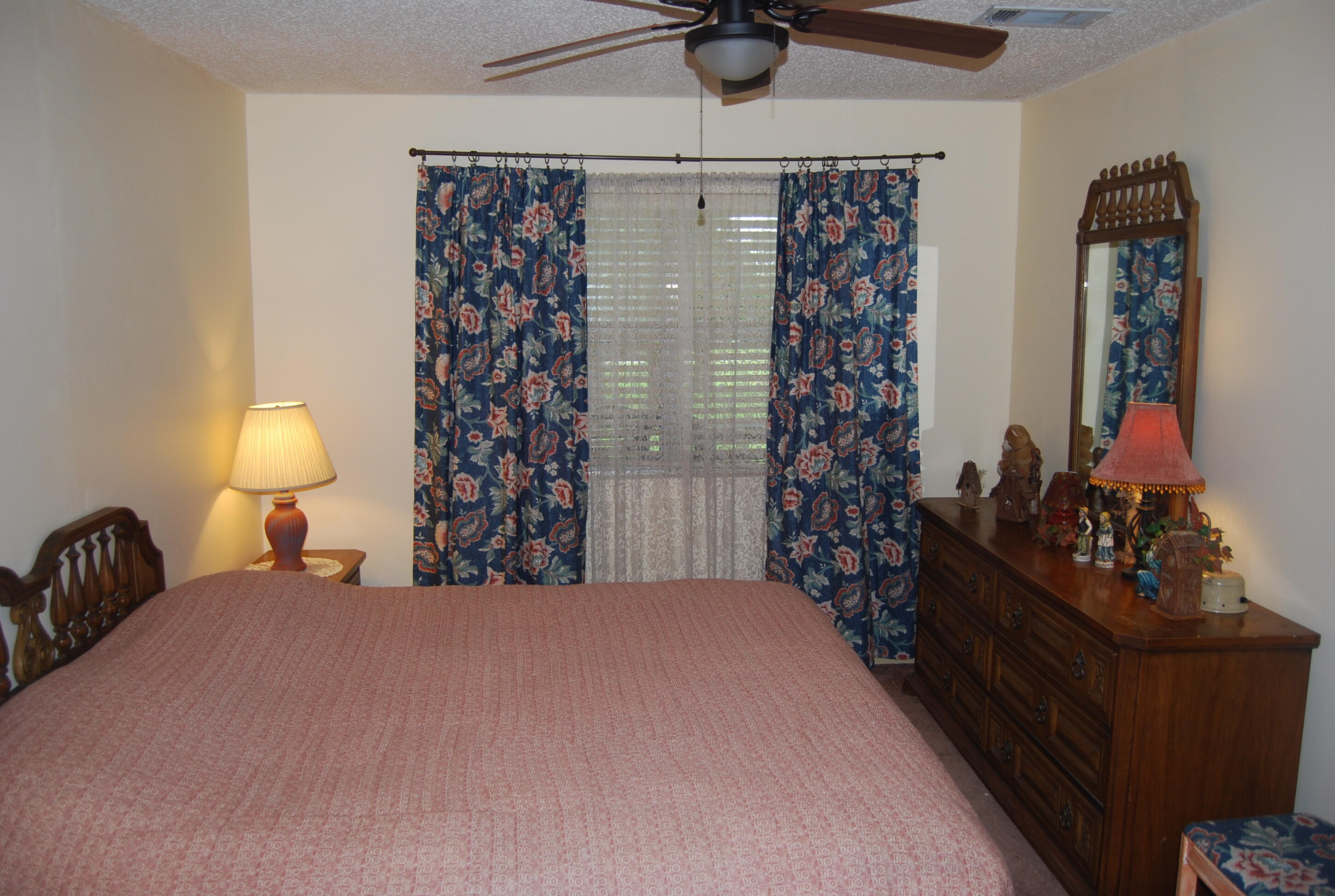 791 Dr Nelson Road DeFuniak Springs, FL 32433 - Photo 12 of 46 a bedroom with a bed and a lamp on the dresser