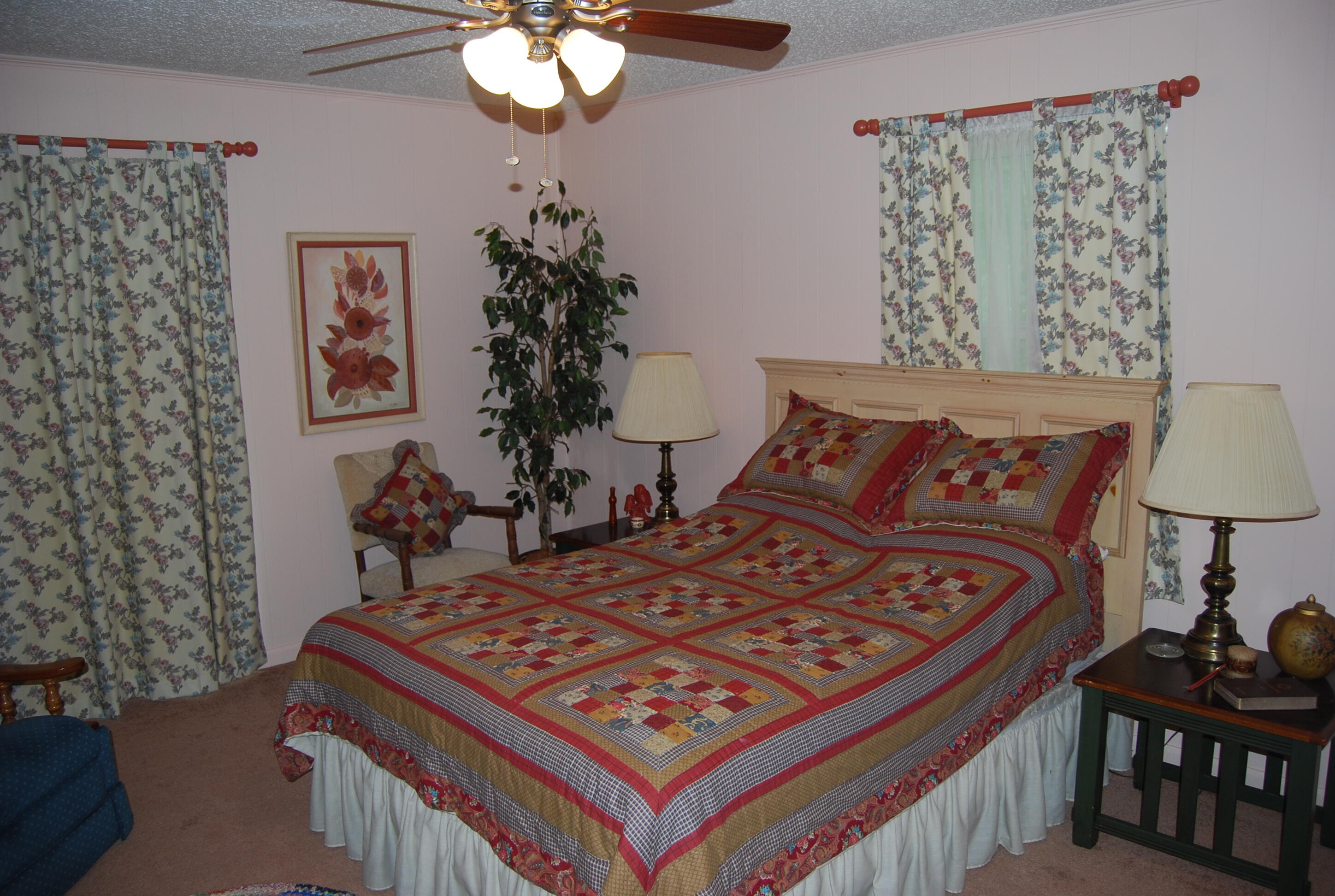 791 Dr Nelson Road DeFuniak Springs, FL 32433 - Photo 17 of 46 a bed sitting in a bedroom next to a lamp with a small yard