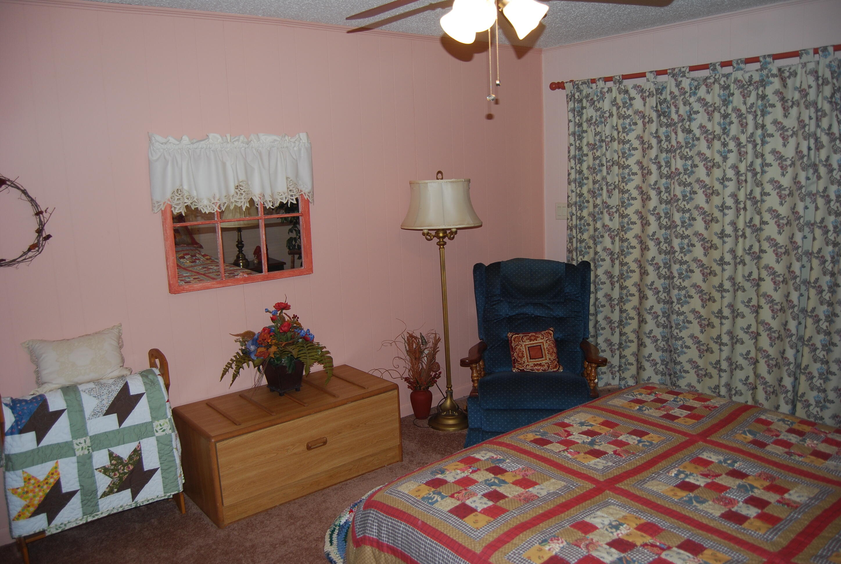 791 Dr Nelson Road DeFuniak Springs, FL 32433 - Photo 18 of 46 a bedroom with a bed and a lamp on dresser