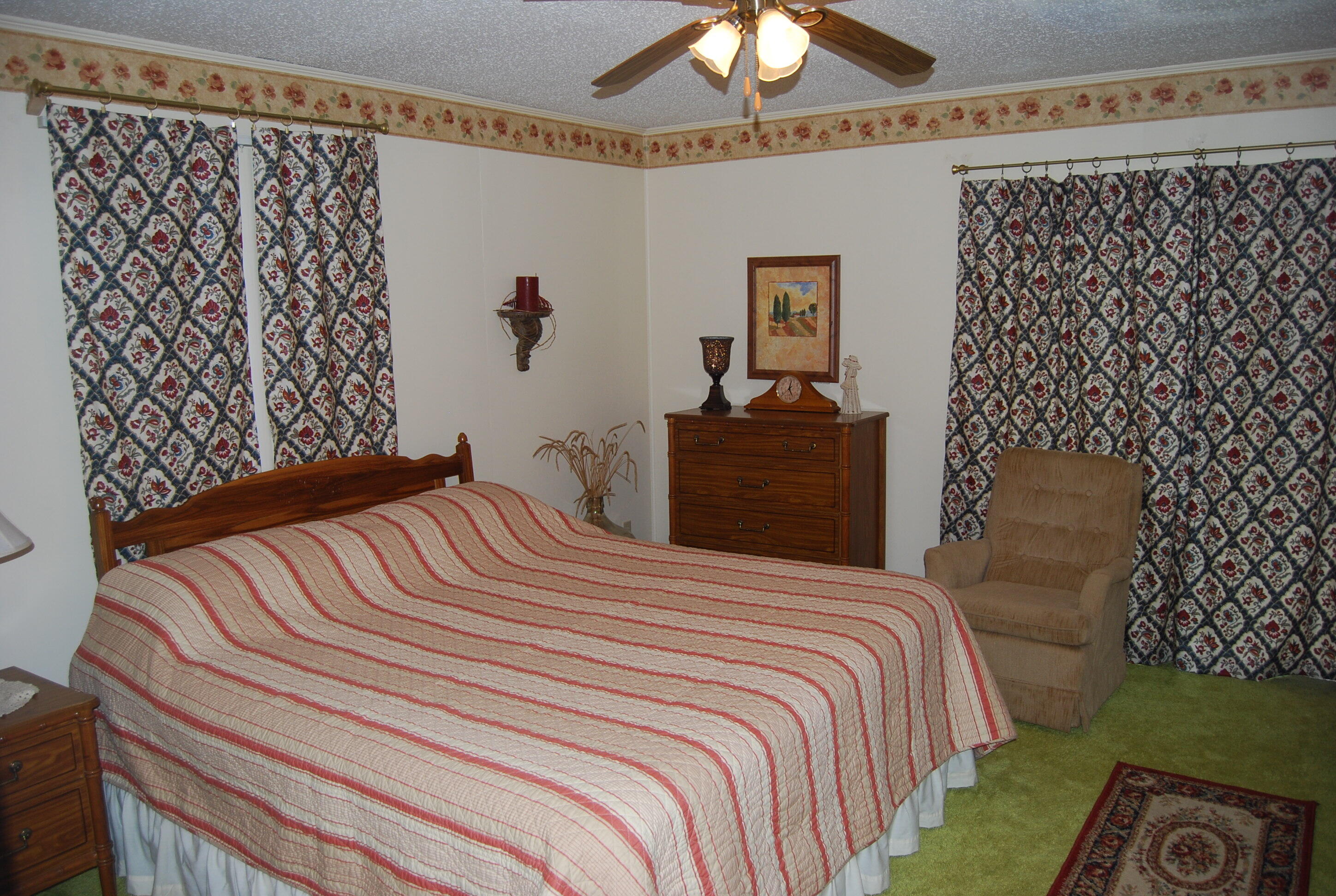 791 Dr Nelson Road DeFuniak Springs, FL 32433 - Photo 19 of 46 a bedroom with a bed and a painting on the wall