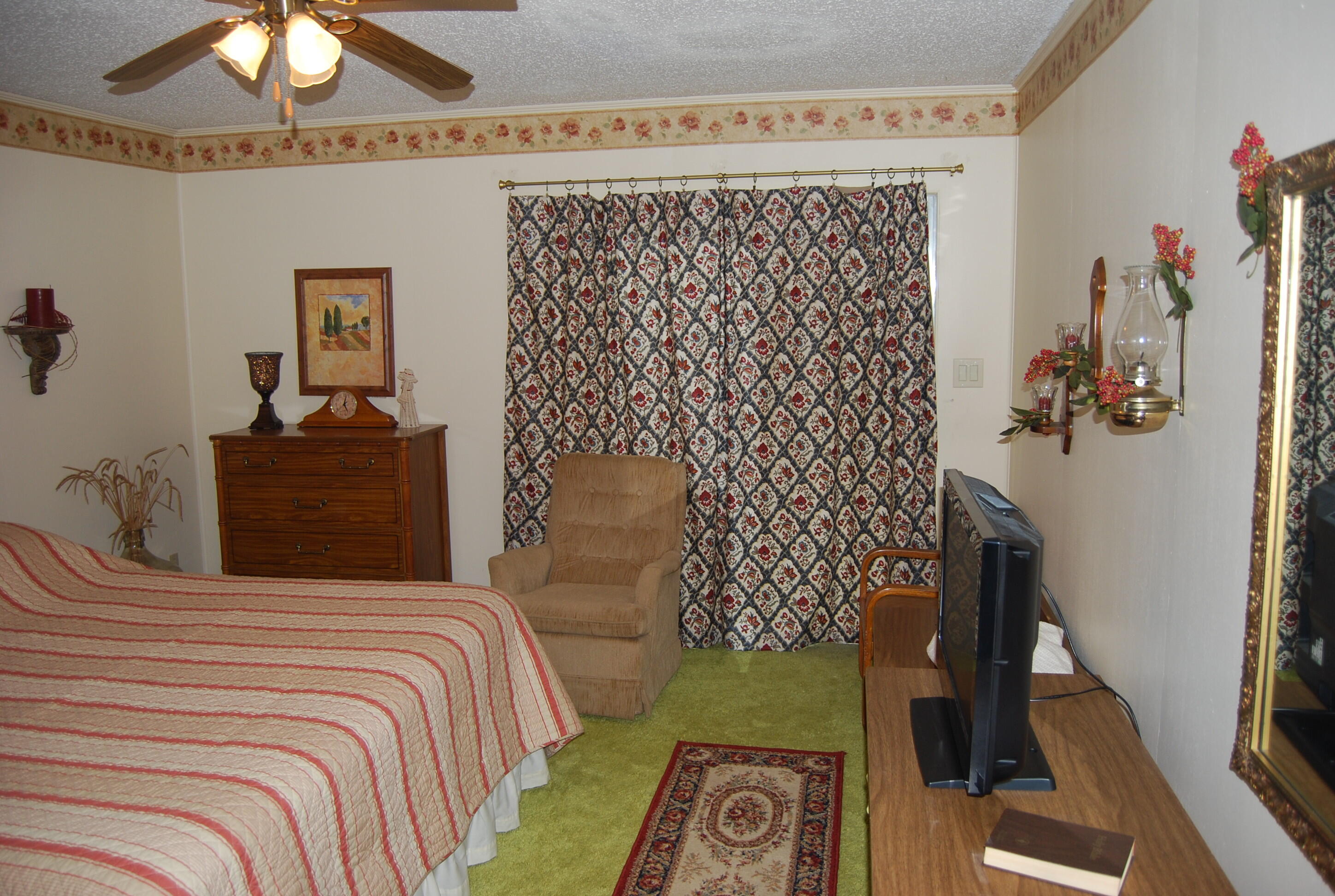 791 Dr Nelson Road DeFuniak Springs, FL 32433 - Photo 20 of 46 a bedroom with a bed and a chandelier