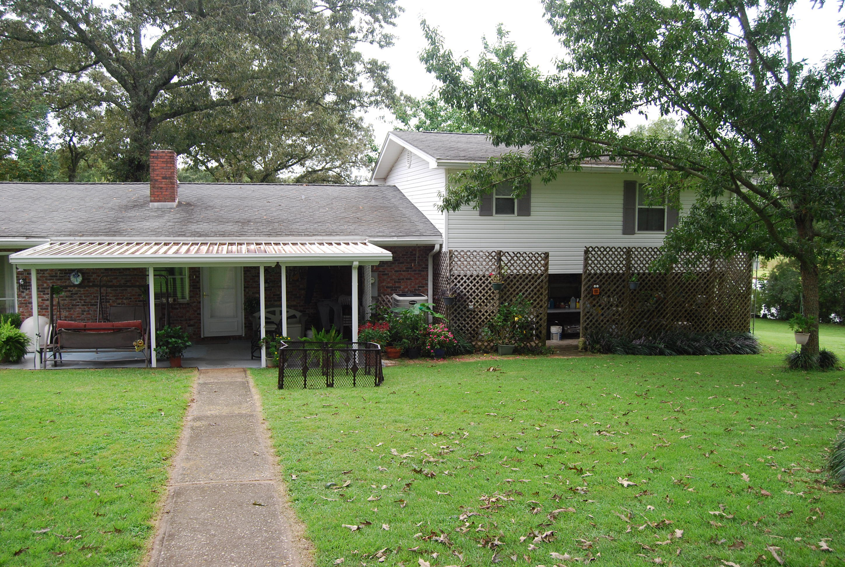 791 Dr Nelson Road DeFuniak Springs, FL 32433 - Photo 29 of 46 a front view of a house with a garden and trees