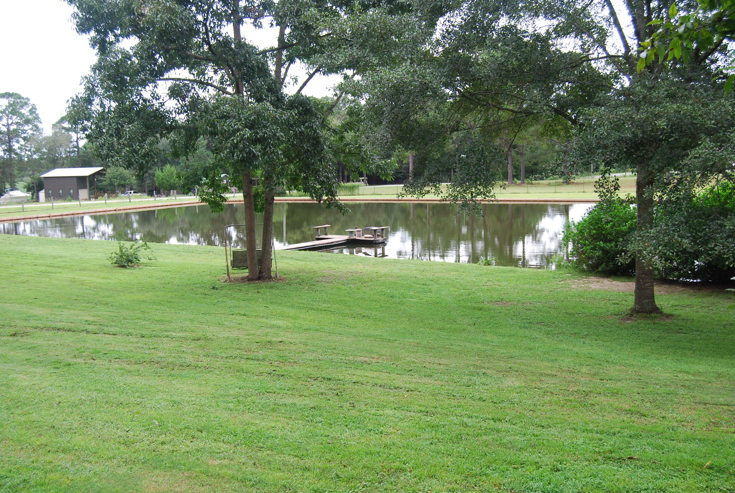 791 Dr Nelson Road DeFuniak Springs, FL 32433 - Photo 4 of 46 a backyard of a house with lots of green space and lake view