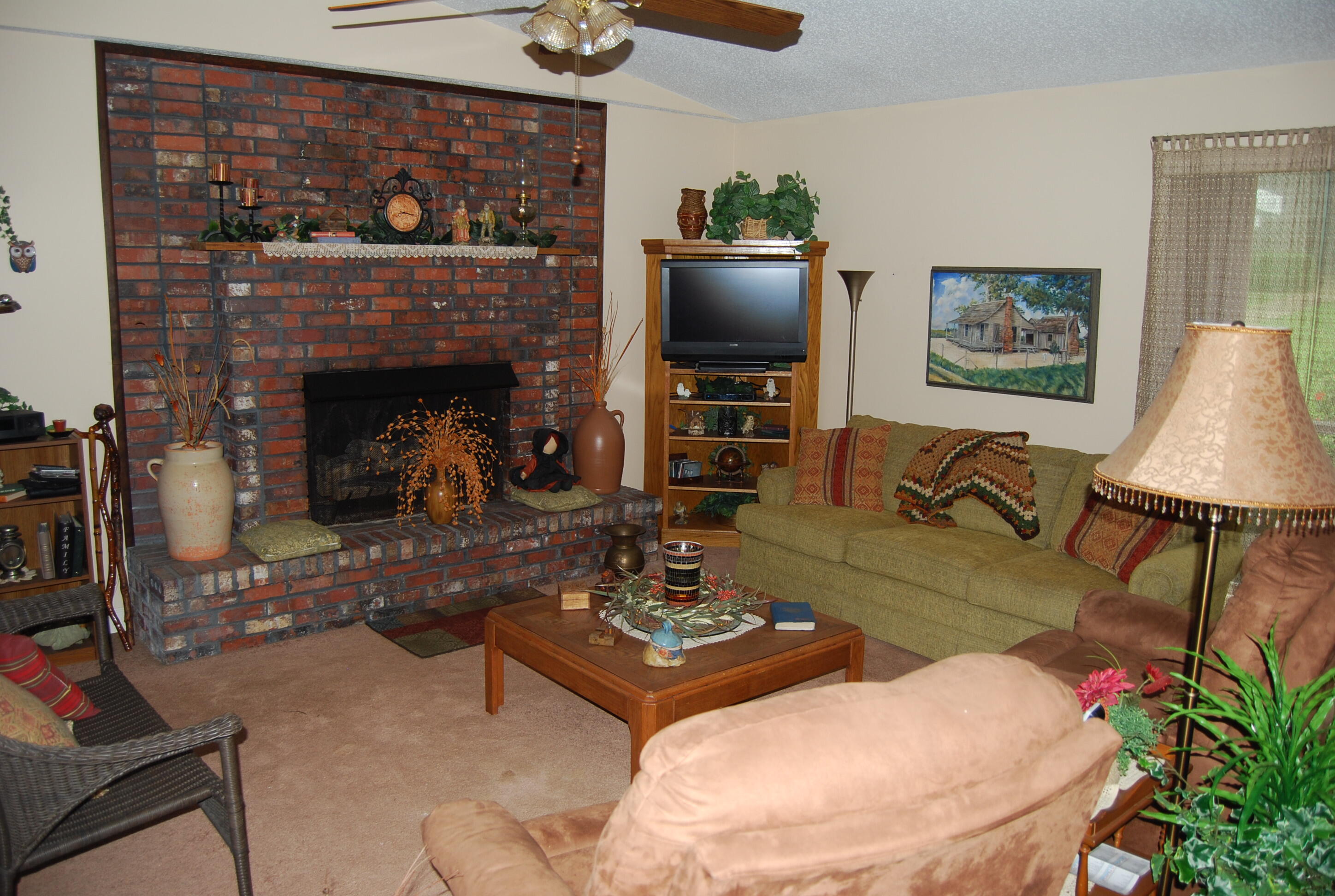 791 Dr Nelson Road DeFuniak Springs, FL 32433 - Photo 8 of 46 a living room with furniture a flat screen tv and a fireplace