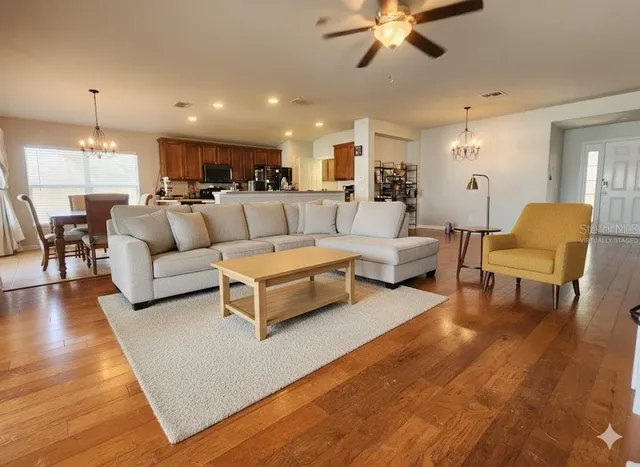 a living room with furniture and a chandelier