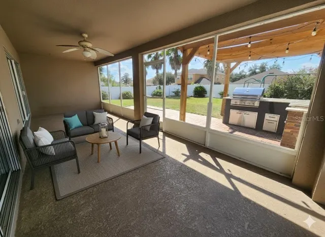 a living room with furniture and a floor to ceiling window