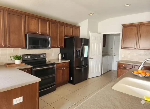 a kitchen with a refrigerator stove and microwave