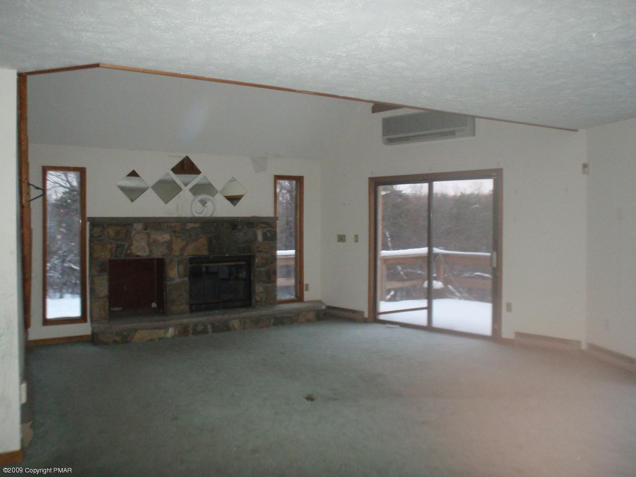 5733 North Clover Road Long Pond, PA 18334 - Photo 3 of 5 an empty room with a fireplace