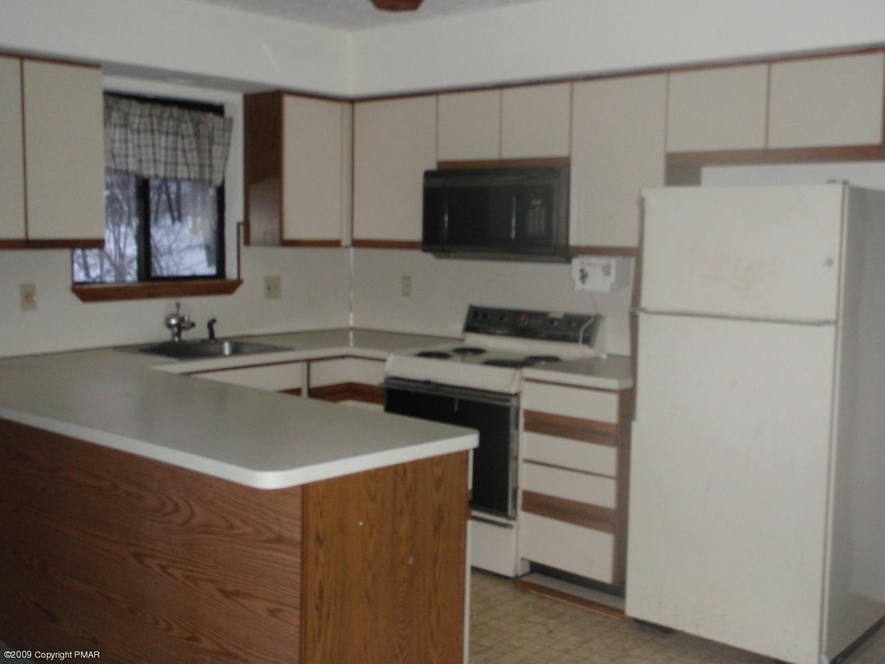 5733 North Clover Road Long Pond, PA 18334 - Photo 4 of 5 a kitchen with a sink a stove and a refrigerator