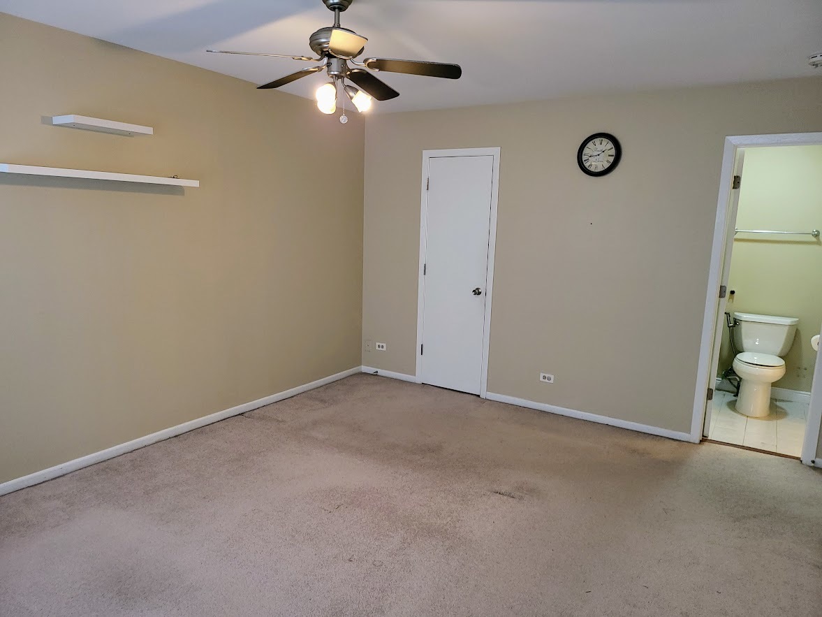 216 Ivy Court Streamwood, IL 60107 - Photo 11 of 14 a view of an empty room and a fan