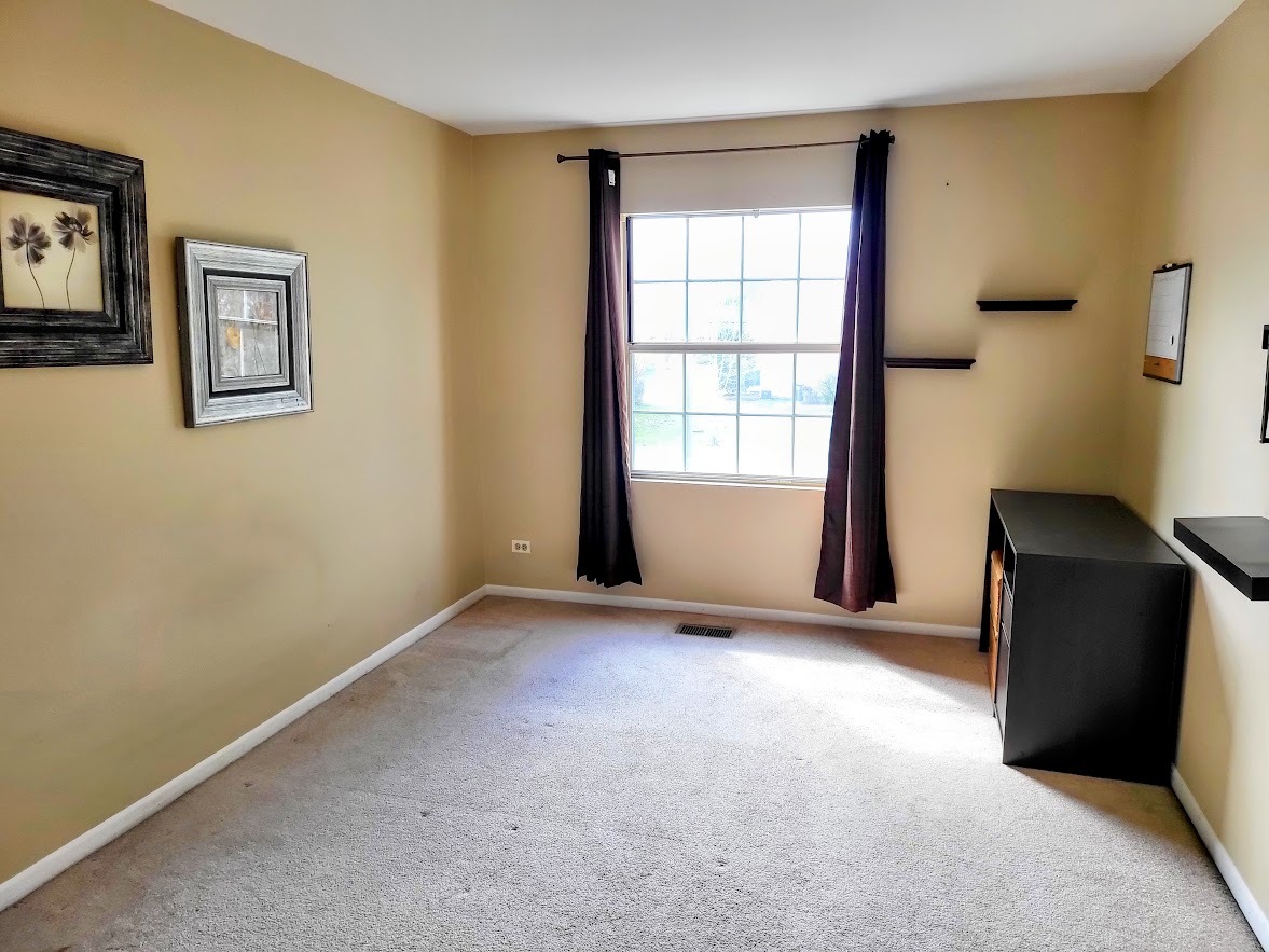 216 Ivy Court Streamwood, IL 60107 - Photo 13 of 14 a view of an empty room with a window