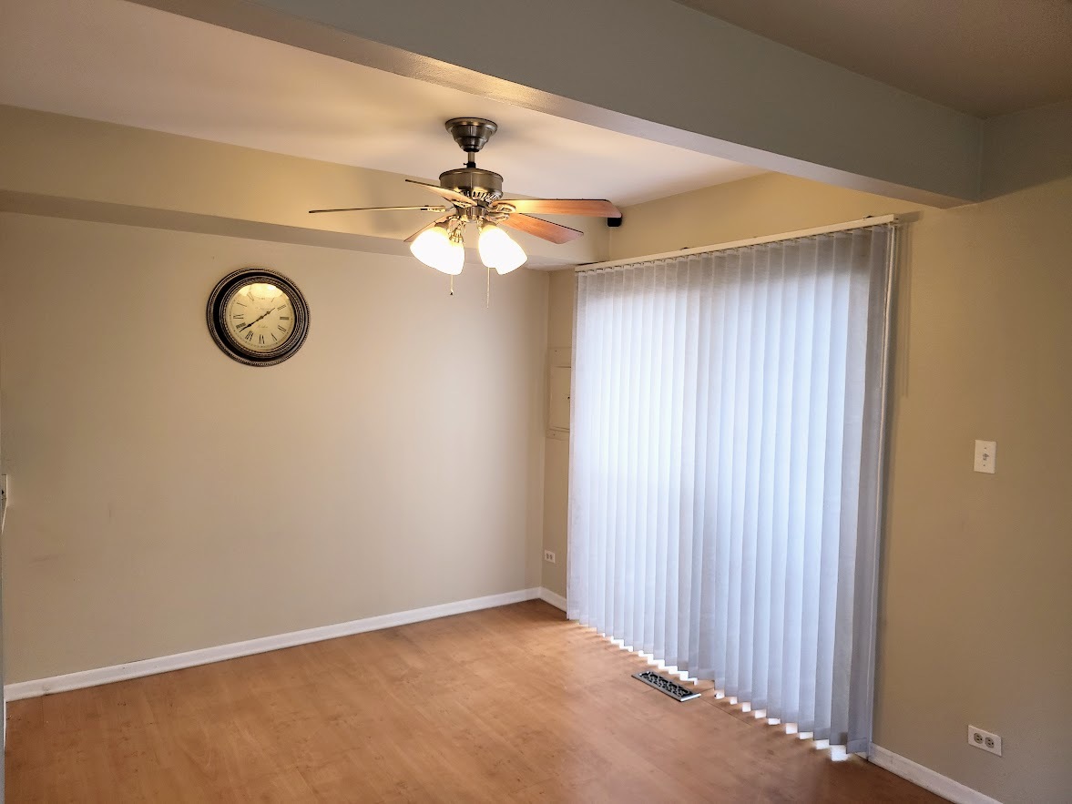 216 Ivy Court Streamwood, IL 60107 - Photo 5 of 14 an empty room with a fan and a fan