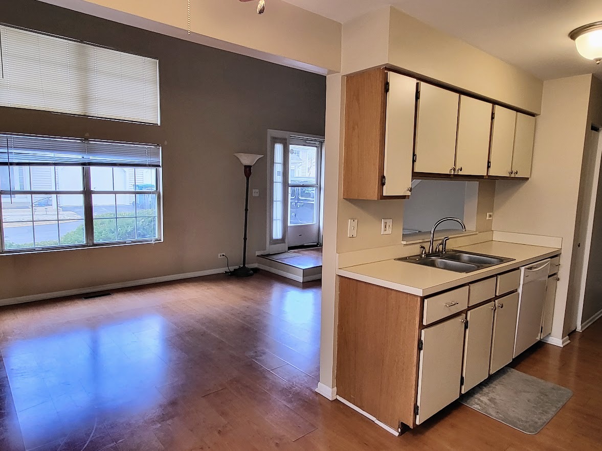 216 Ivy Court Streamwood, IL 60107 - Photo 6 of 14 a kitchen with stainless steel appliances granite countertop a stove a sink and a microwave