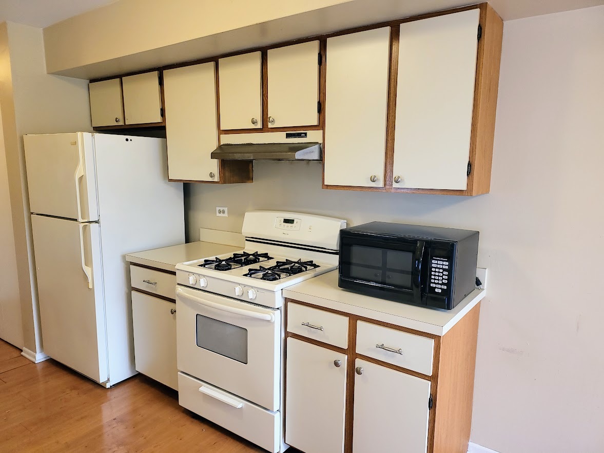 216 Ivy Court Streamwood, IL 60107 - Photo 8 of 14 a kitchen with stainless steel appliances a stove sink and cabinets