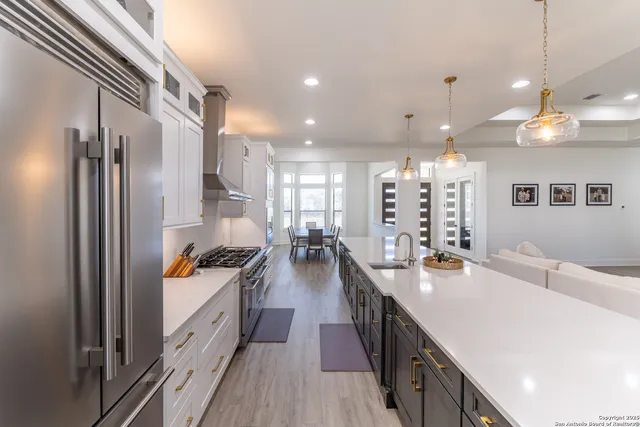 a spacious bathroom with a granite countertop sink a toilet a mirror and shower