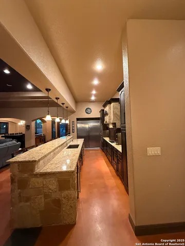 a kitchen with granite countertop a refrigerator and a stove