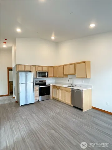 a kitchen with a refrigerator and a stove top oven