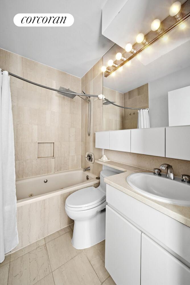 455 East 86th Street, Unit 11AB Manhattan, NY 10028 - Photo 9 of 15 a bathroom with a sink a toilet and bathtub