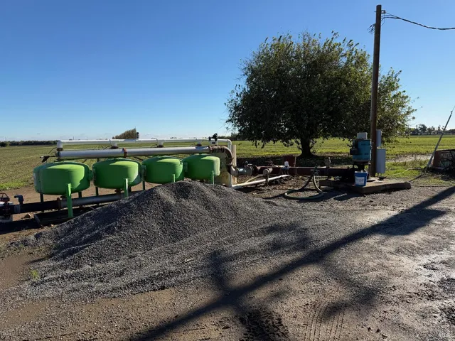 a view of a childrens park with large trees