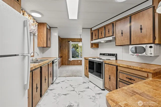 a kitchen with a stove a sink and a refrigerator