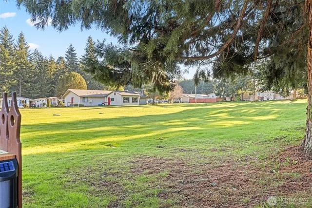 a backyard of a house with table and chairs