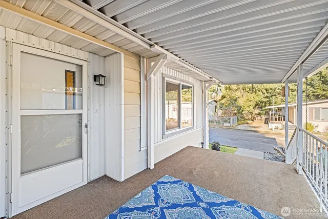a view of a porch with wooden floor and windows