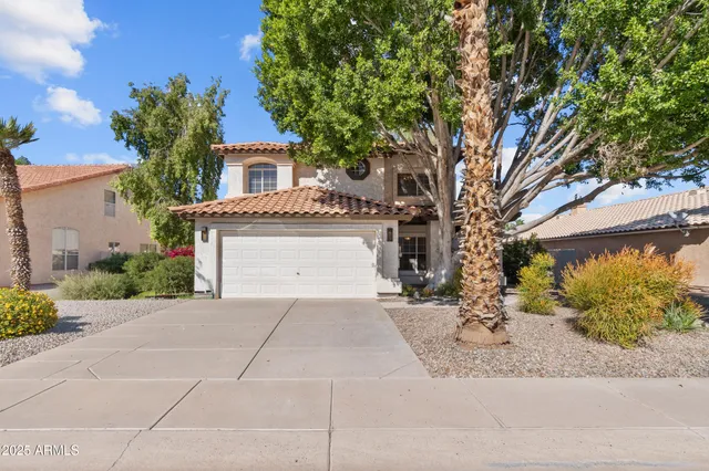 a front view of a house with a yard and a garage