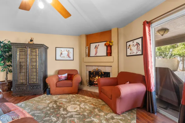 a living room with furniture a rug and a window