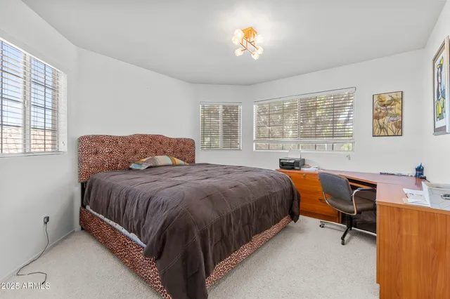 a spacious bedroom with a bed and a desk