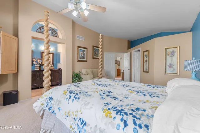 a bedroom with a bed and ceiling fan