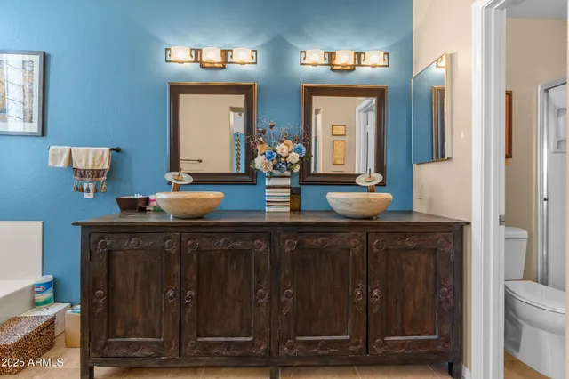 a bathroom with double vanity sinks a vanity and a mirror