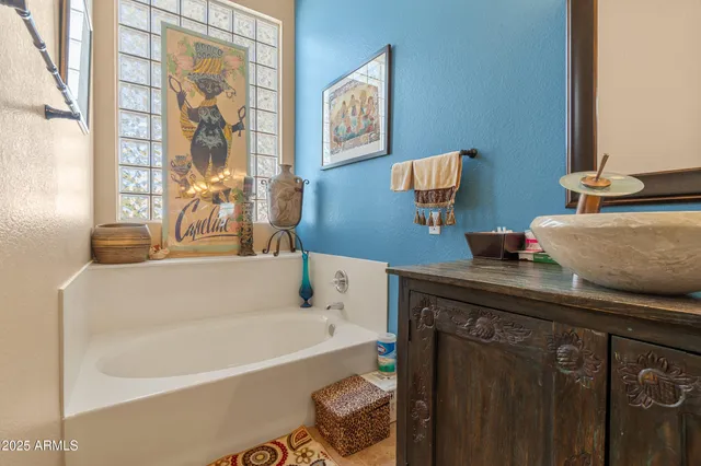 a bathroom with a tub sink and a mirror