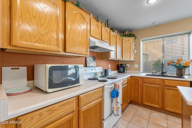 a kitchen with stainless steel appliances granite countertop a sink and a stove
