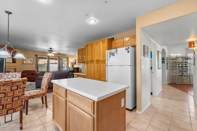 a kitchen with a refrigerator a oven and a sink
