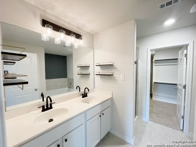 5015 Dancing Gopher San Antonio, TX 78261 - Photo 11 of 43 a bathroom with double sink and two mirror