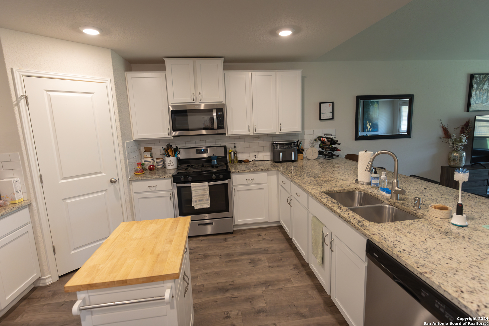 5015 Dancing Gopher San Antonio, TX 78261 - Photo 22 of 43 a kitchen with kitchen island granite countertop a sink counter top space stainless steel appliances and cabinets