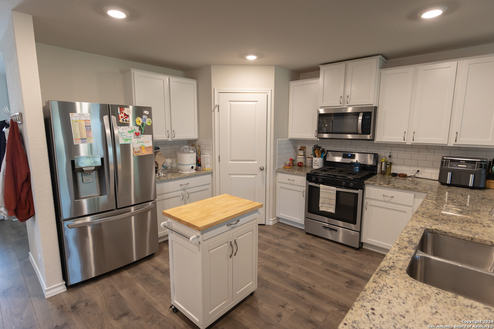 5015 Dancing Gopher San Antonio, TX 78261 - Photo 23 of 43 a kitchen with stainless steel appliances a refrigerator stove microwave and sink