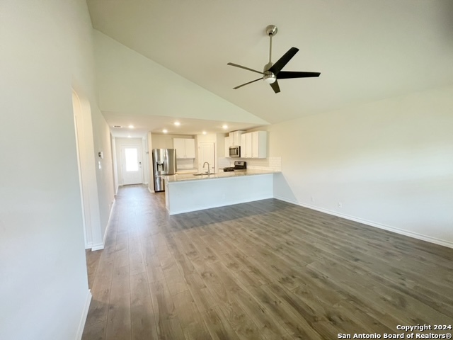 5015 Dancing Gopher San Antonio, TX 78261 - Photo 7 of 43 a view of a kitchen with wooden floor and a kitchen view
