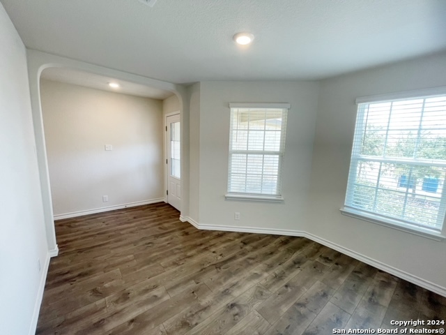 5015 Dancing Gopher San Antonio, TX 78261 - Photo 9 of 43 an empty room with wooden floor and windows