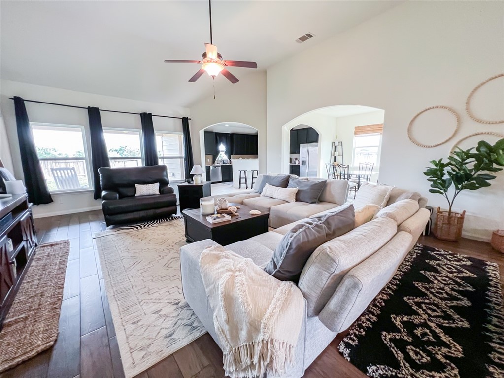 a living room with furniture chandelier and a fireplace