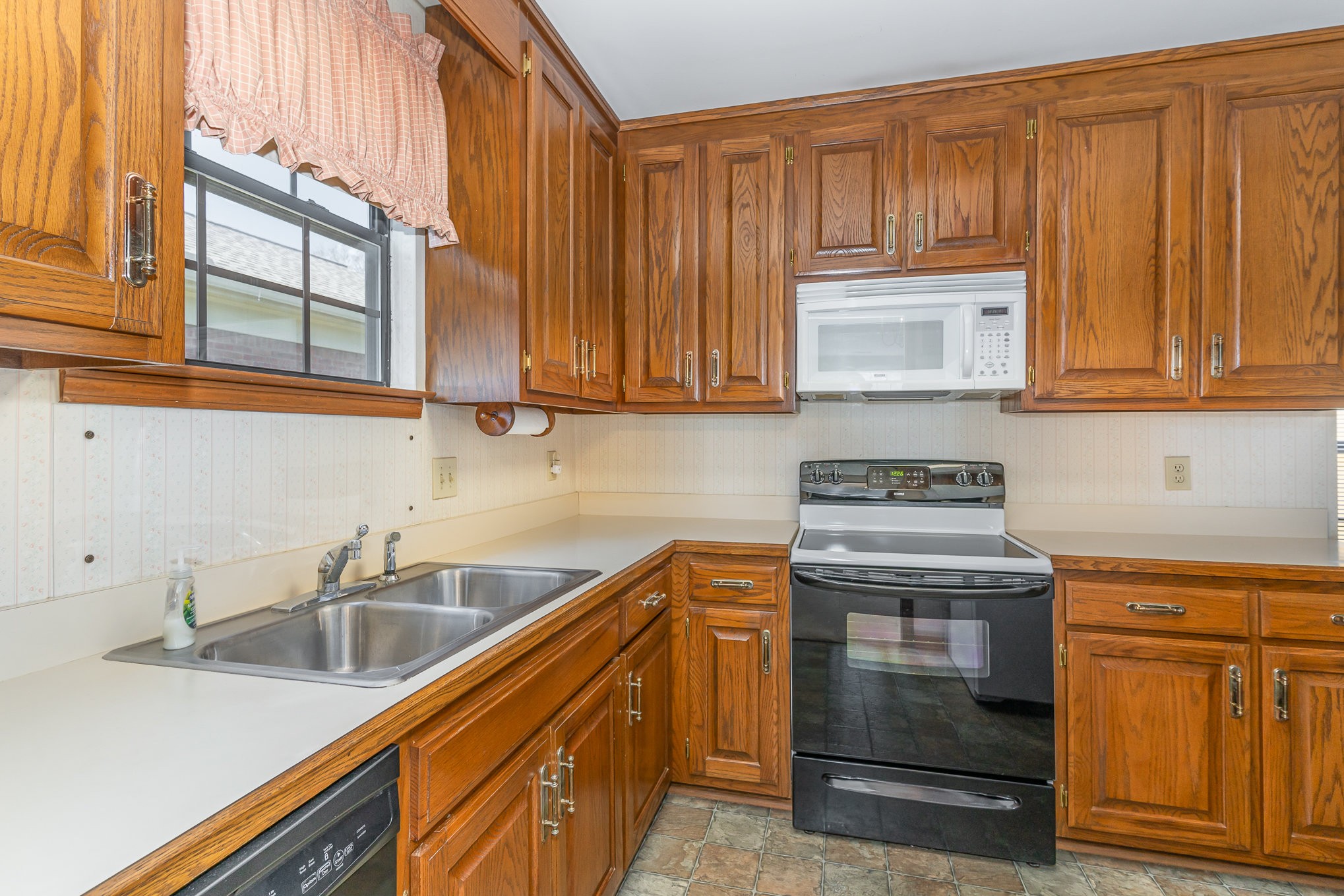 636 General George Patton Road Nashville, TN 37221 - Photo 13 of 32 a kitchen with stainless steel appliances granite countertop a sink a stove and cabinets