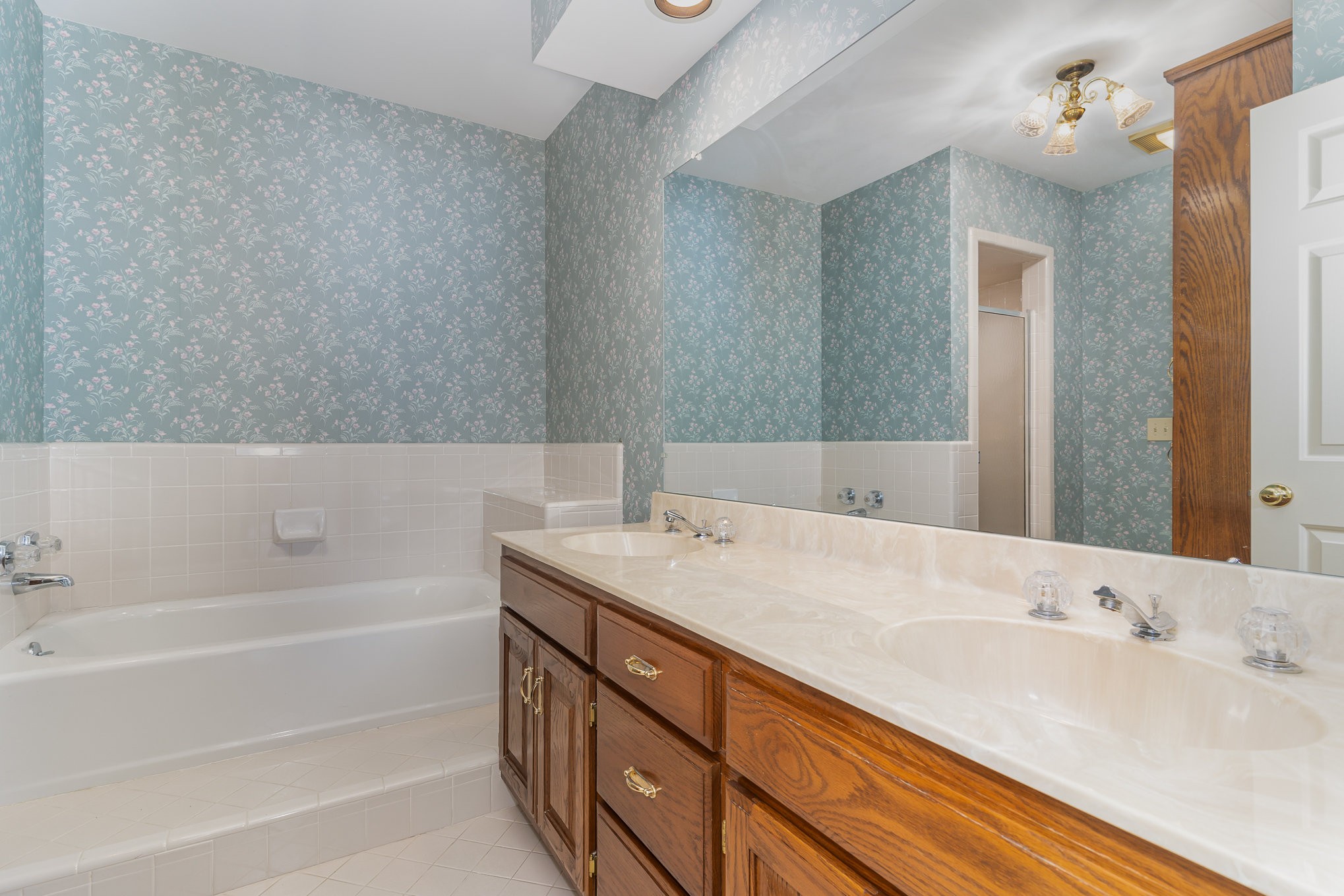 636 General George Patton Road Nashville, TN 37221 - Photo 20 of 32 a bathroom with a tub sink and mirror