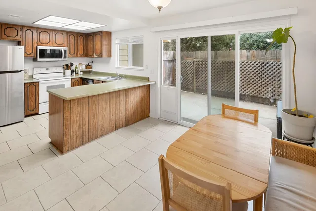 a kitchen with stainless steel appliances a refrigerator sink and cabinets